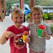 two boys eating snowcones